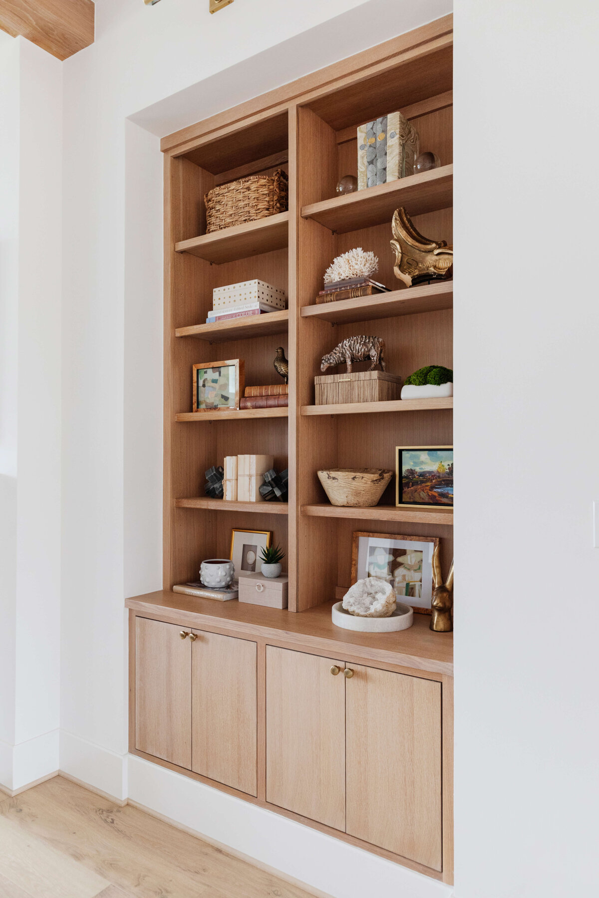 oyster creek studios missouri city new build wooden shelves with baskets artwork and sculptures on wall