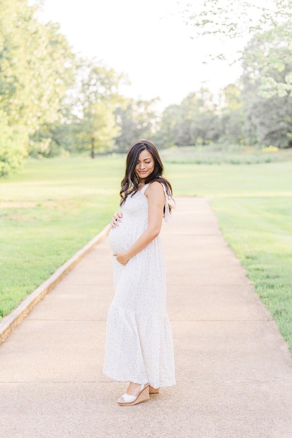 mom peacefully looking at belly taken by a maternity photographer in Northern Virginia