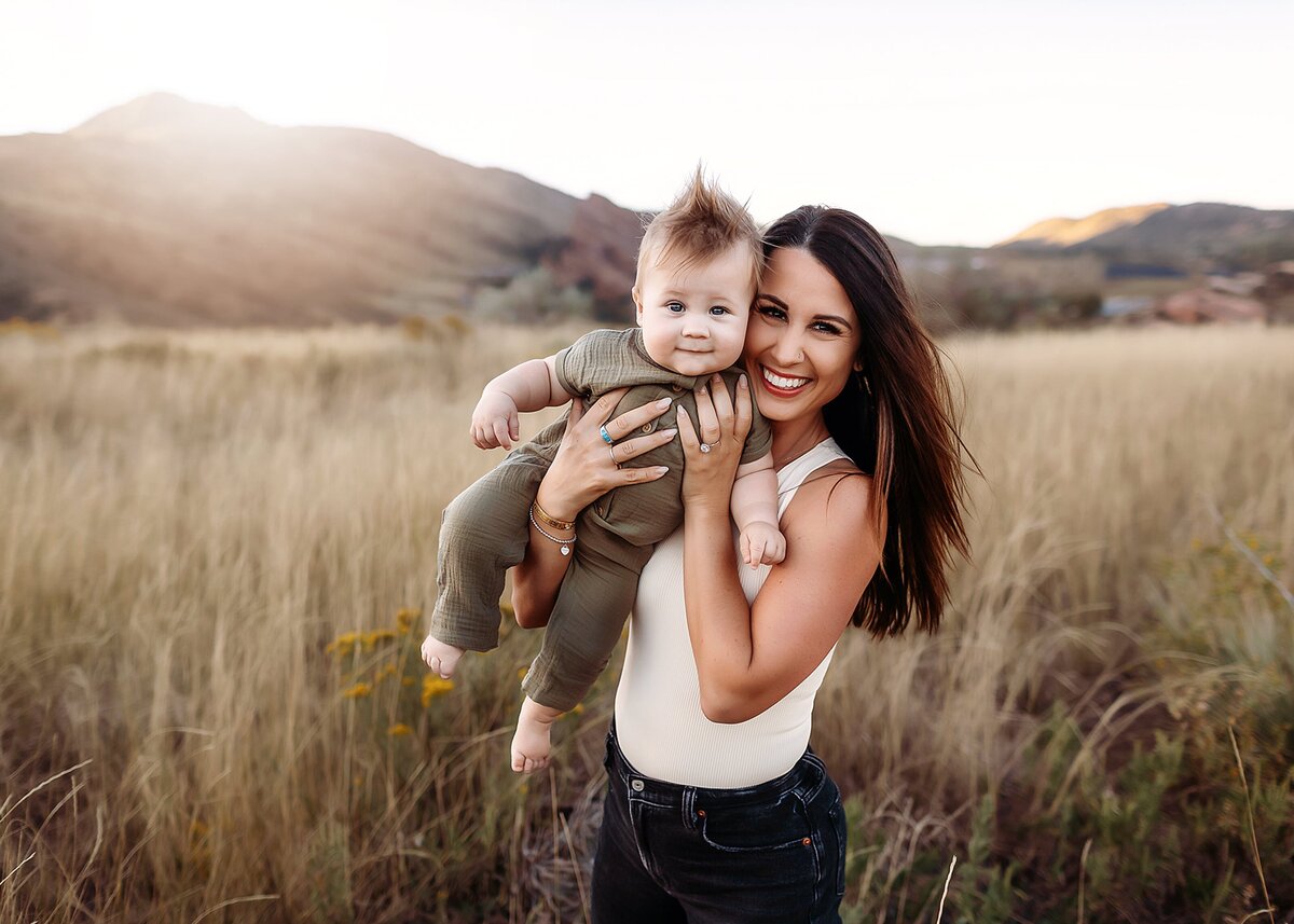 mom and her baby boy playing at red rocks during golden hour