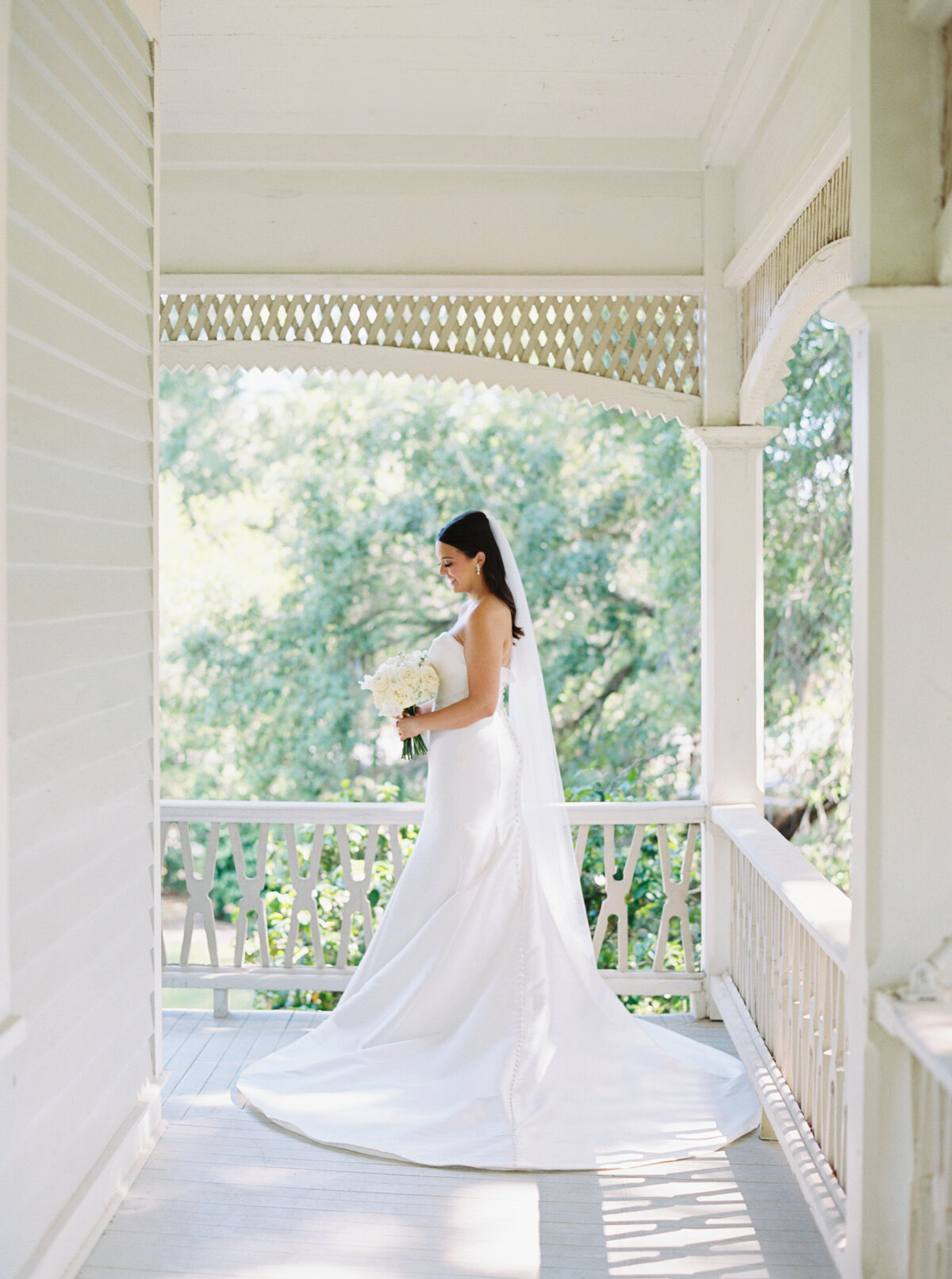 A timeless bridal portrait set against the backdrop of the 1891 Victorian mansion, the John Nickerson House in Lafayette, LA, beautifully captured on film by Morgan Alysse, Louisiana film photographer.