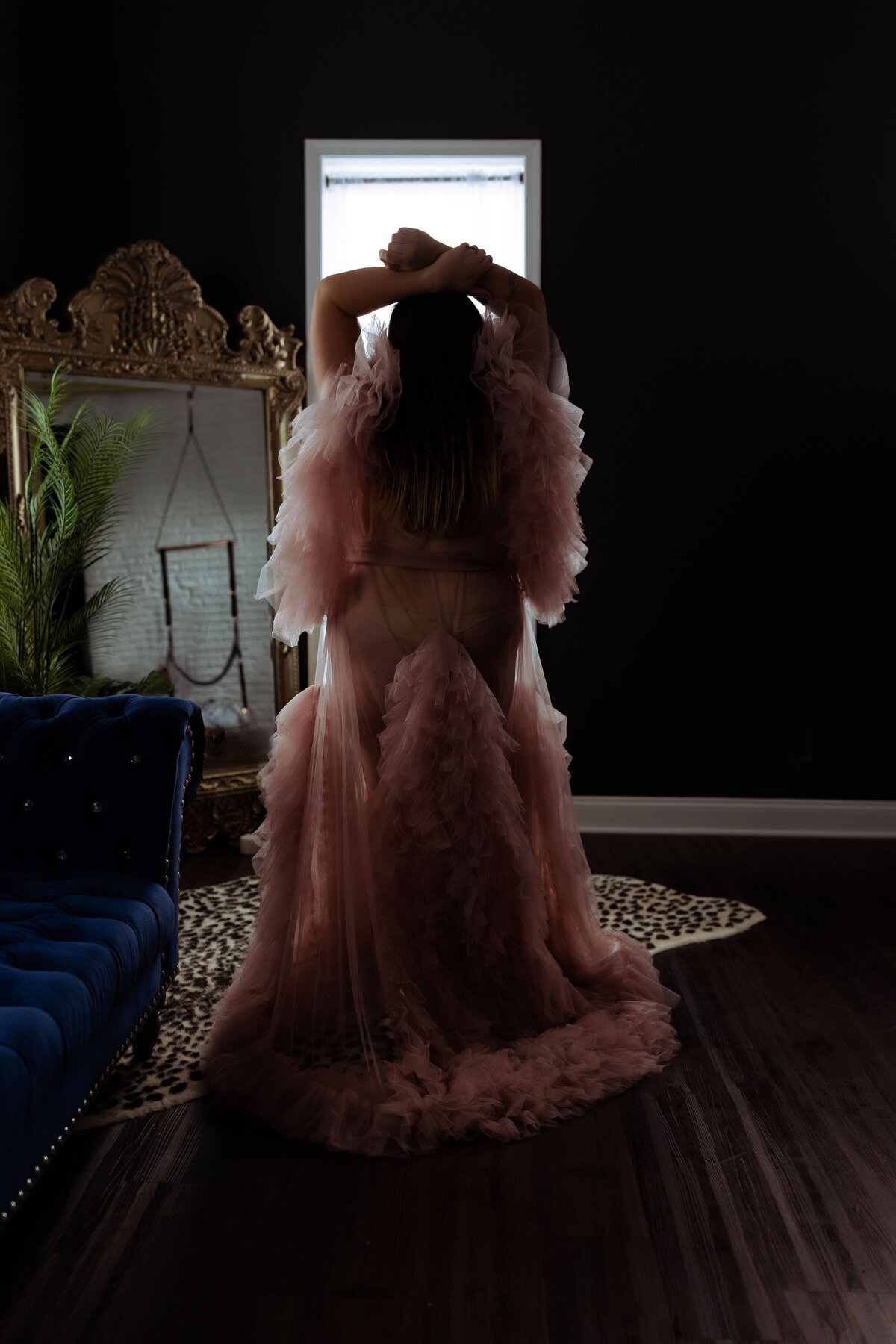 standing woman wearing luxury tulle robe during boudoir session