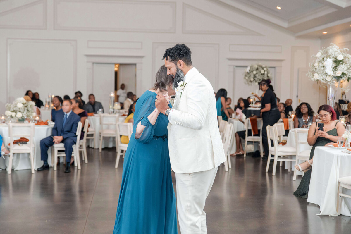 The couple stands together, sharing a heartfelt moment while speaking to their guests.