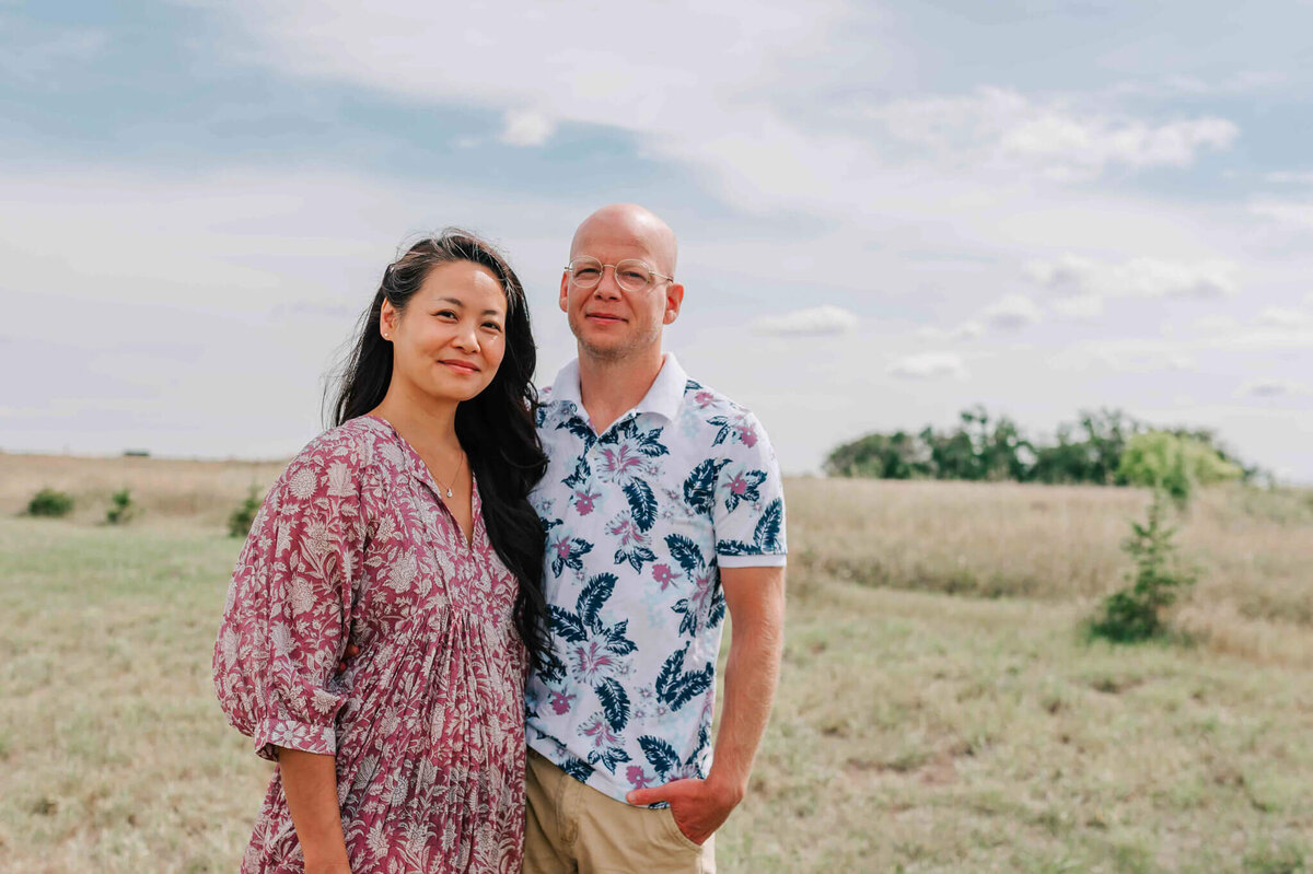 A mom and dad standing next to each other. 