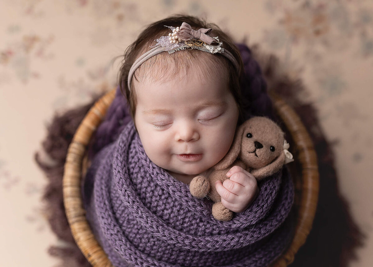 Baby Girl wrapped in purple during her newborn session at Jennifer Brandes Photography.