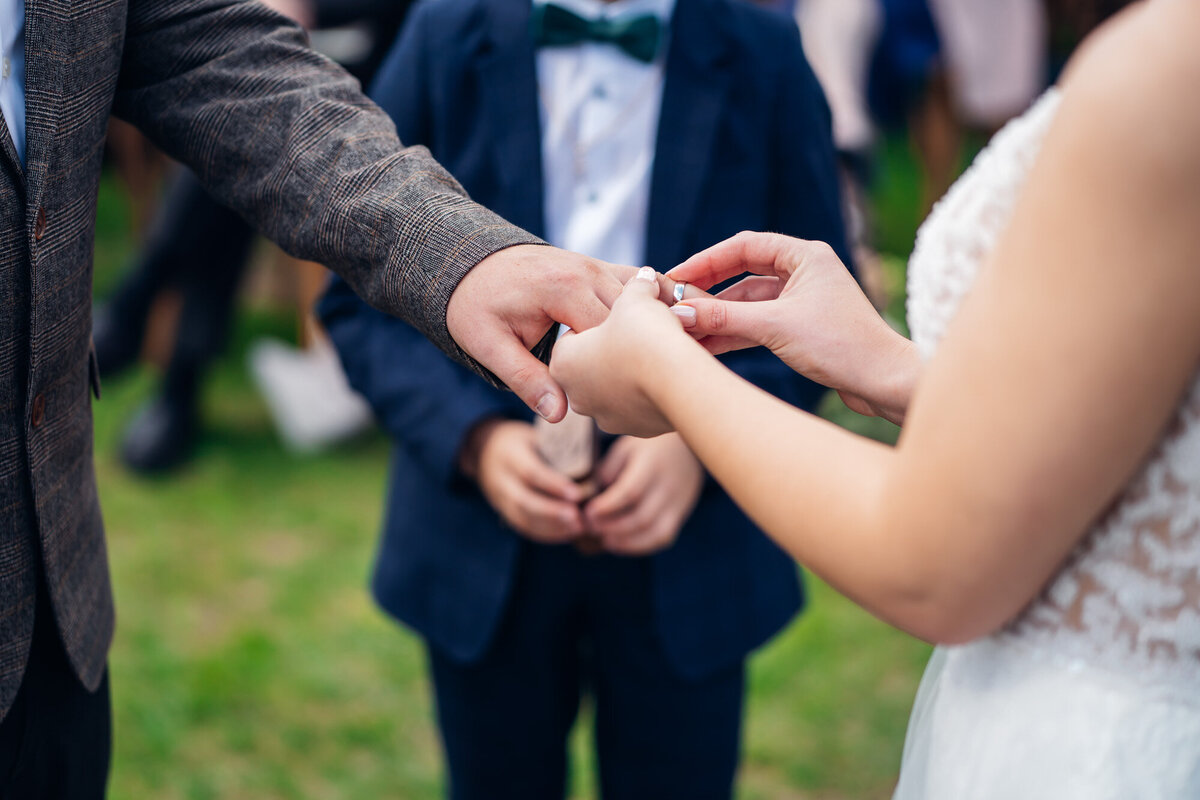 Pauntley-court-wedding-photographer-couple-exchanging-rings