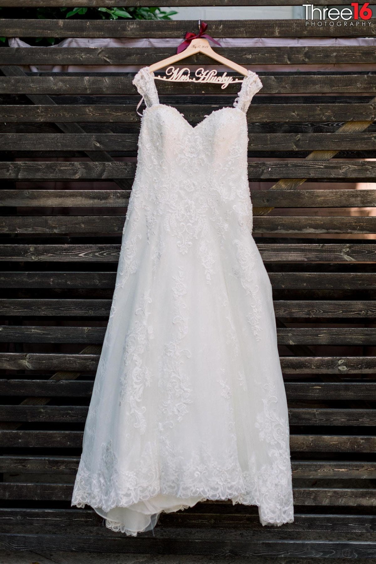 Bride's Wedding Dresses hangs on a rustic background wall