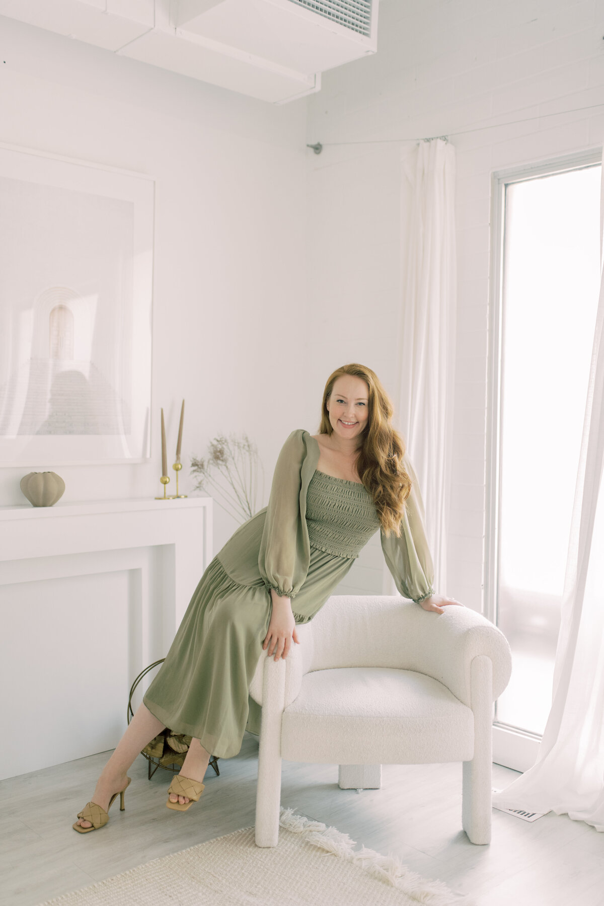 Beautiful girl in green dress at a studio