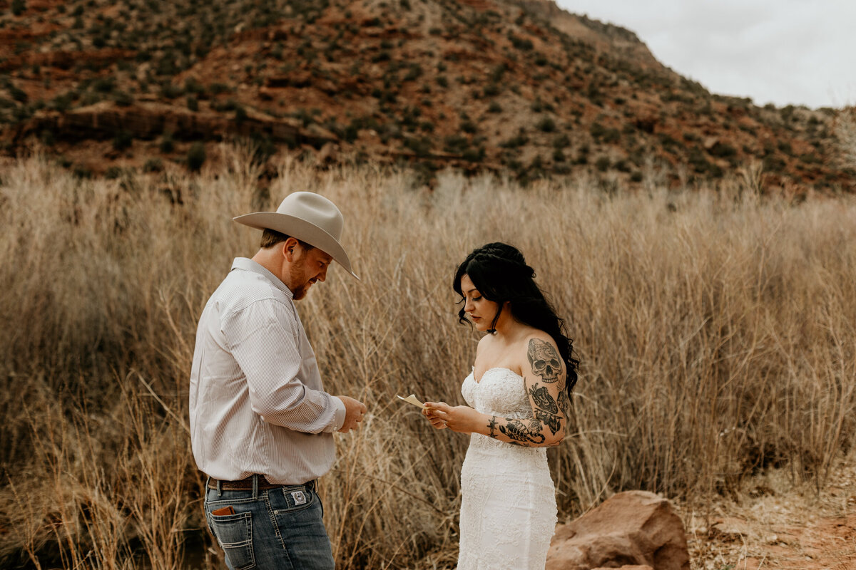 Bride and groom exchanging vows in front of the Jemez Springs red rocks