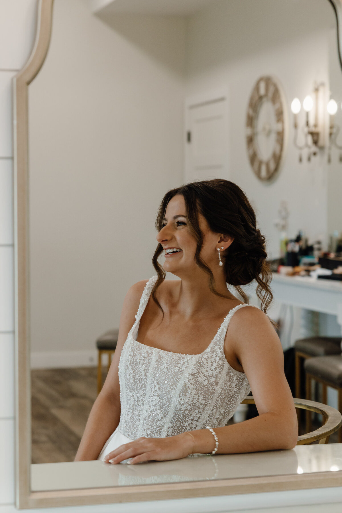 A bride leaning on a desk smiling