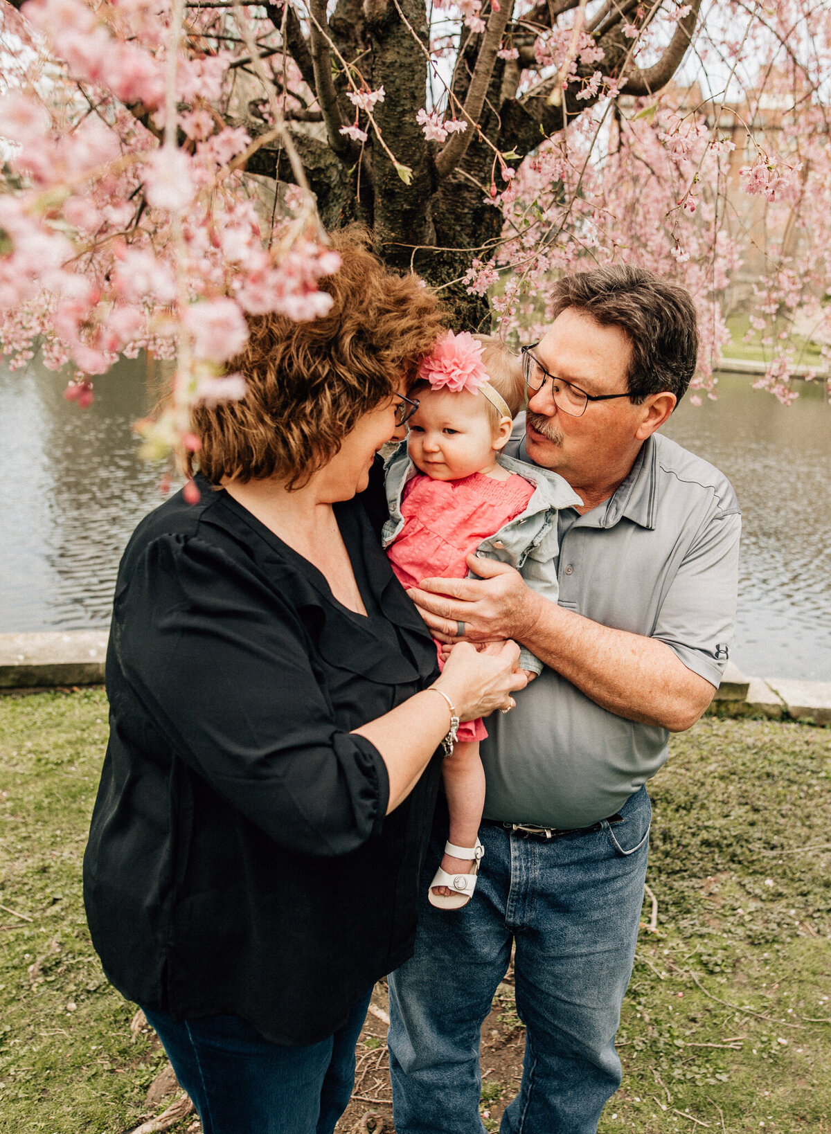 Family lifestyle shot of grandparents holding baby.