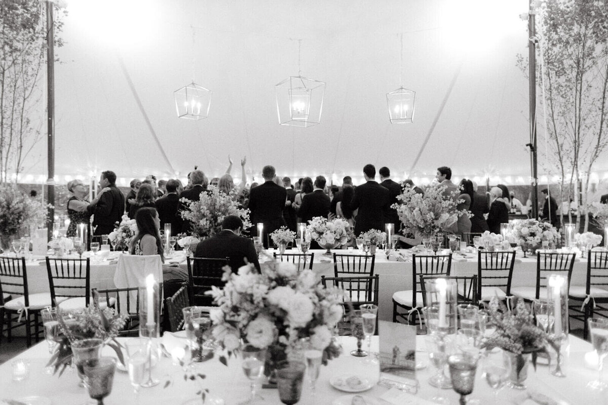 The guests are dancing at the elegant wedding tent reception at Lion Rock Farm, CT. Image by Jenny Fu Studio