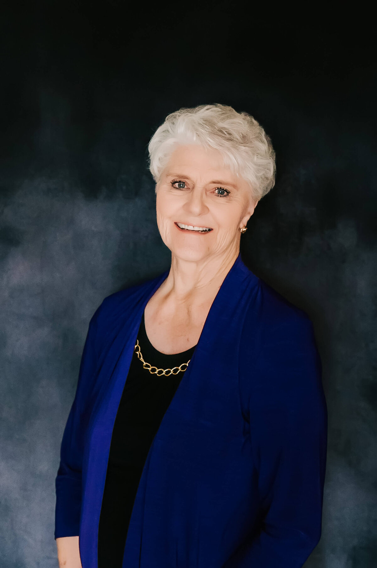 Branson Missouri headshot photographer Jessica Kennedy of The XO Photography captures professional business headshot of woman in purple shirt