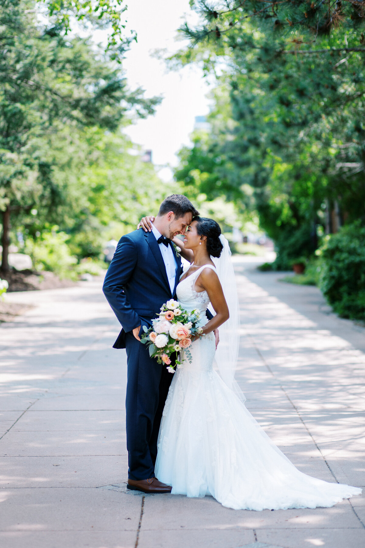 Minnesota bride with groom posing for photo