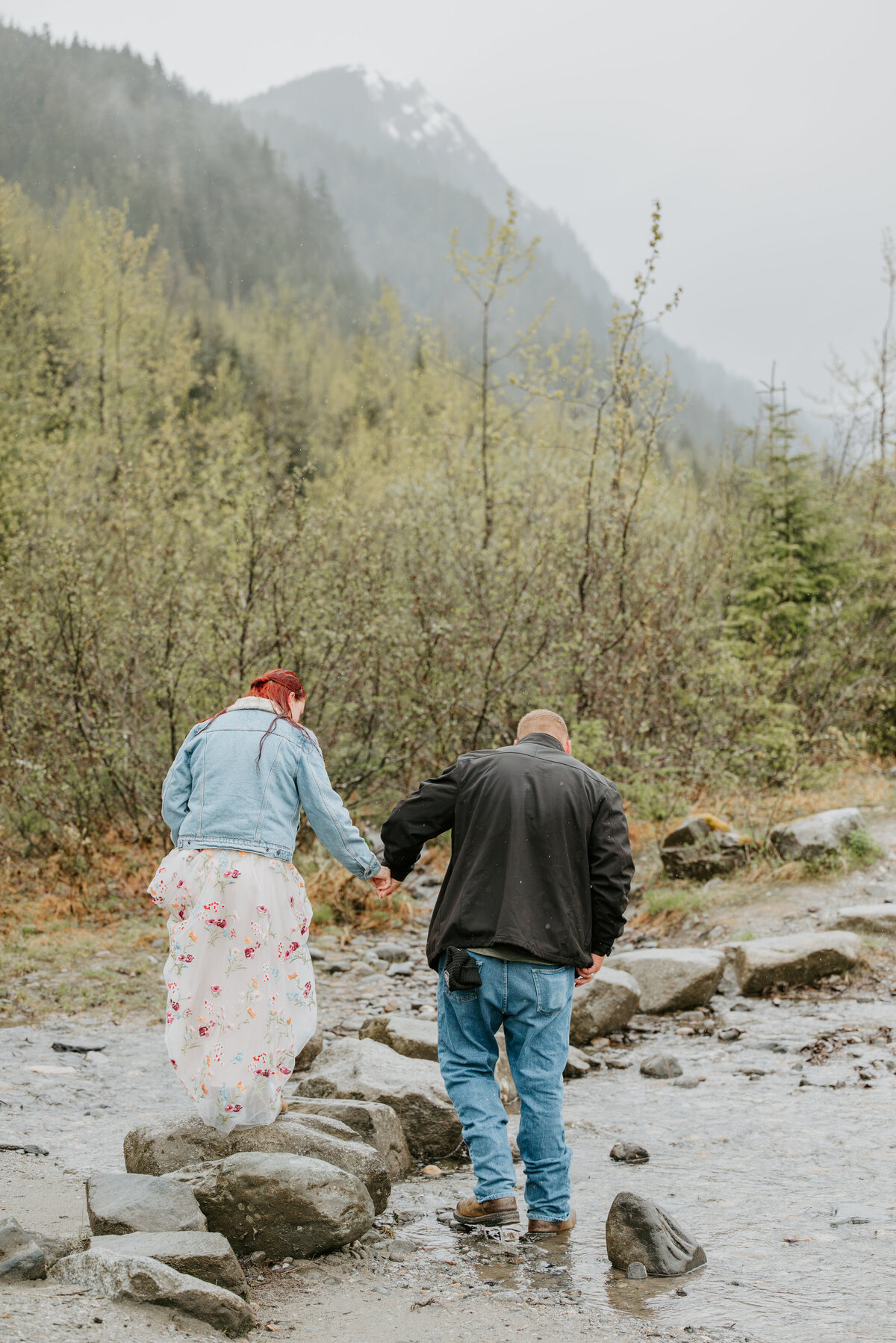 couple skipping over the river