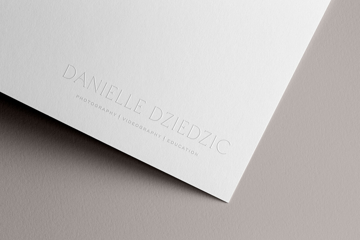 a mockup of a minimal, stylish logo embossed on white paper