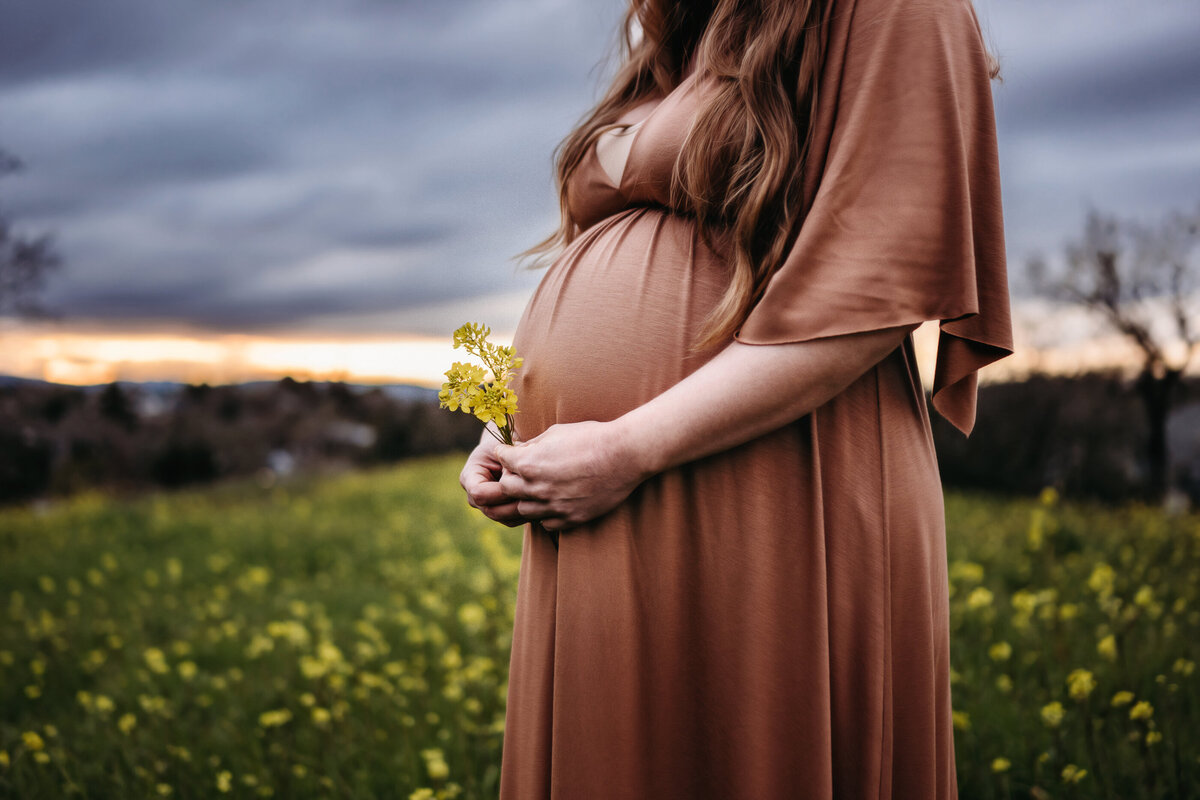 Maternity photo with mustard flower