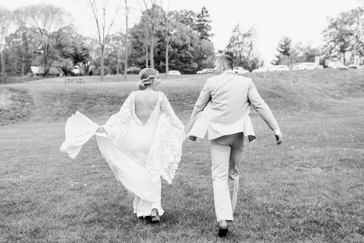 bride and groom running away
