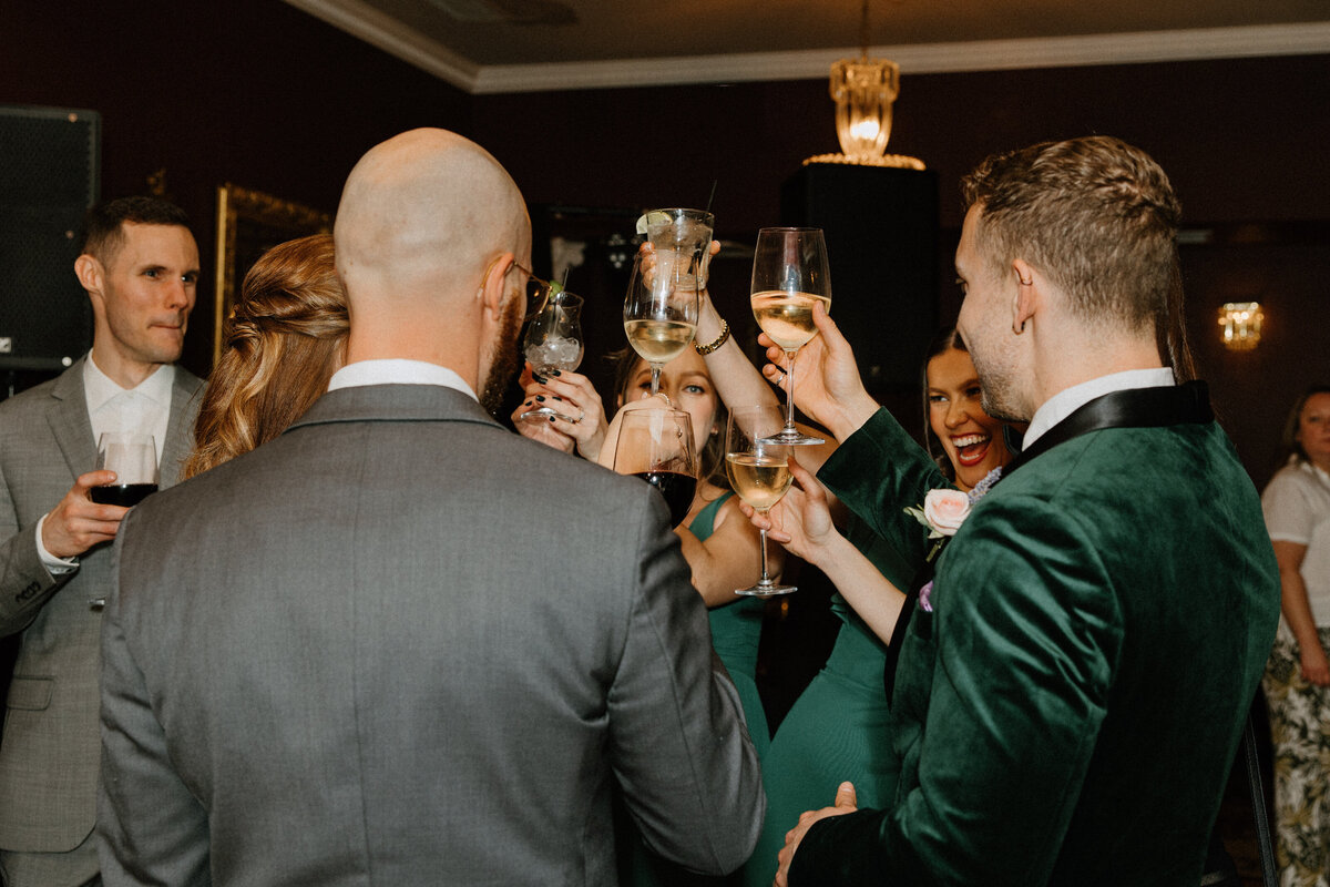 All the bridesmaids and groomsmen sharing a toast to congratulate the newly weds at the reception