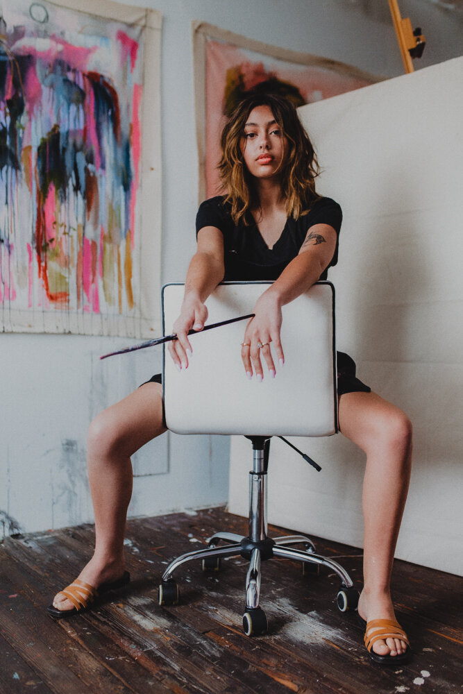 a painter in her studio with a brush