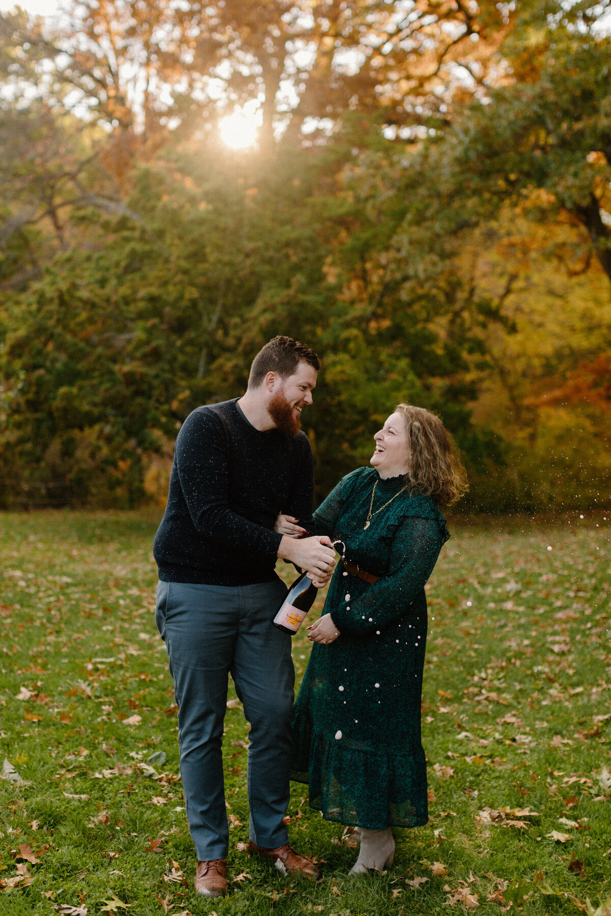 couple popping champagne