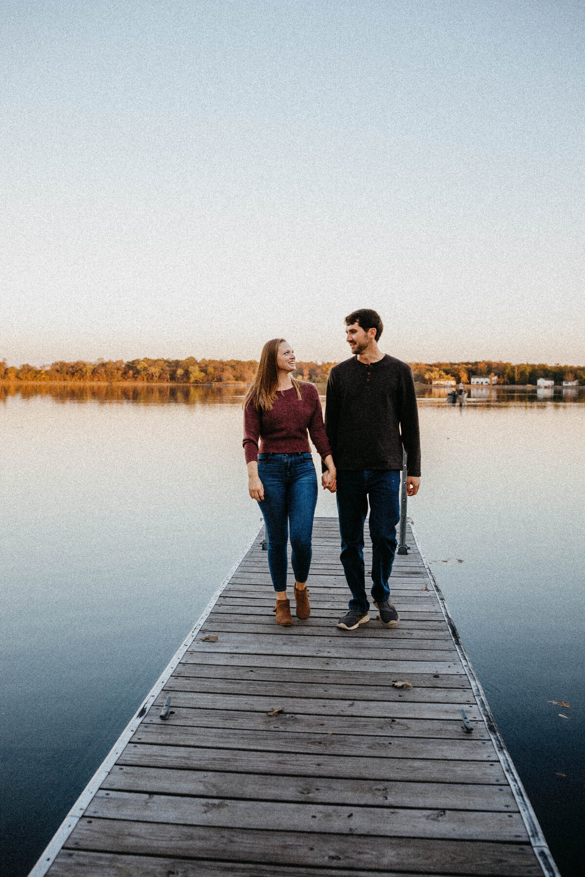 engaged-couple-walking-on-dock