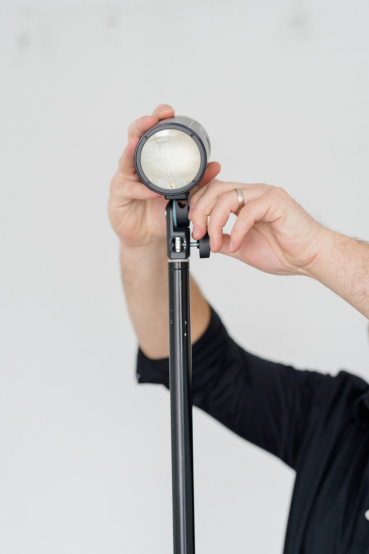 Columbus photographer photographs picture of person adjusting lighting for their photography business
