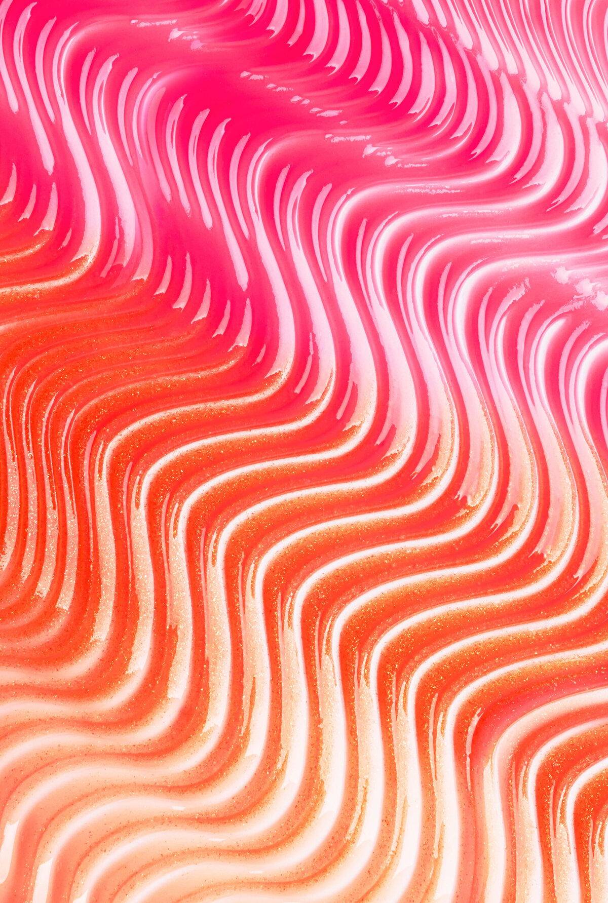 Photographie de texture cosmétique rose et orange, mise en valeur par Studio Helloday.