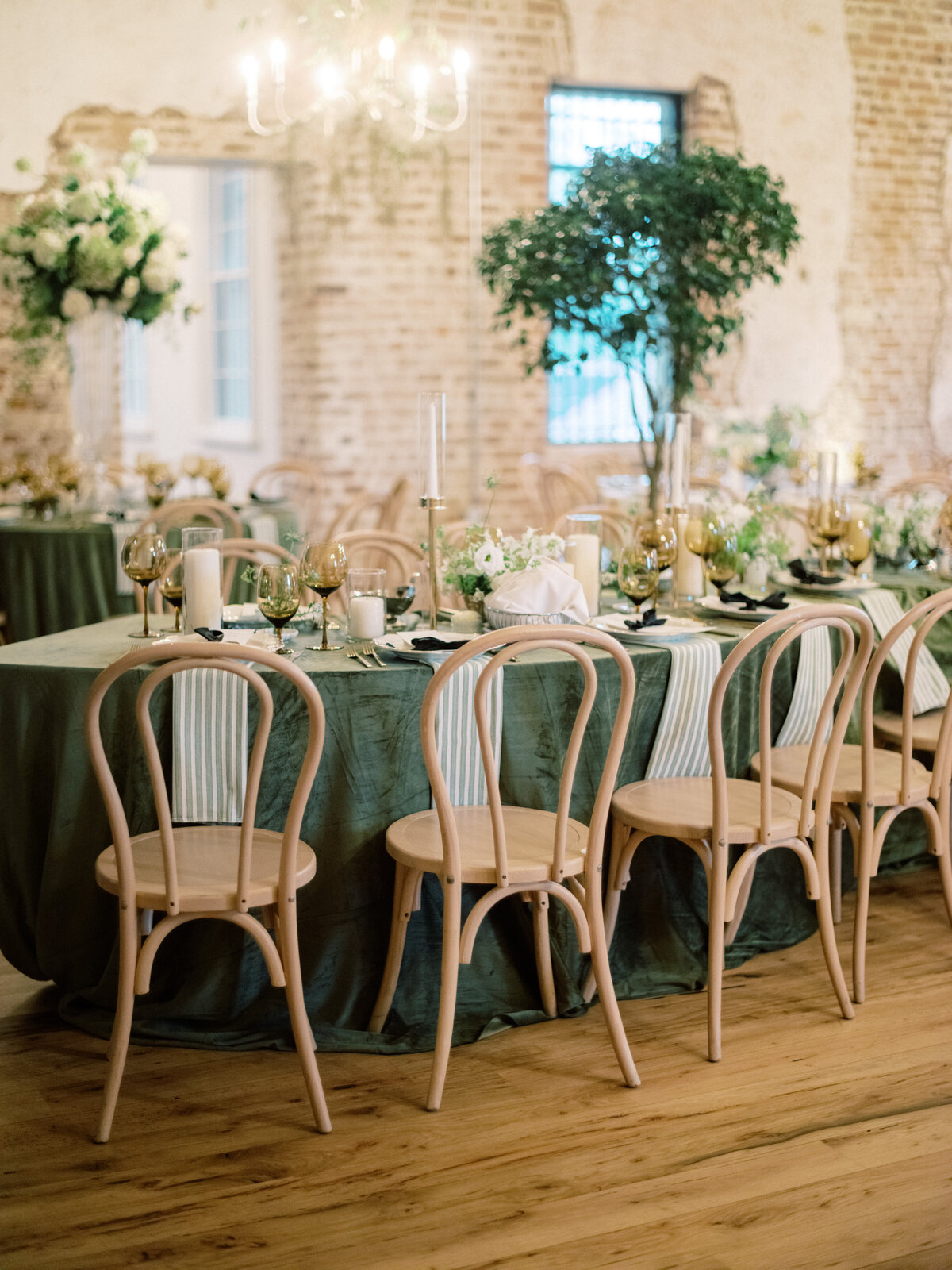 A stunning view of a wedding dining table adorned with tasteful decorations, elegant centerpieces, and a lush, inviting atmosphere that inspires romance and celebration at Twenty-One Magazine.