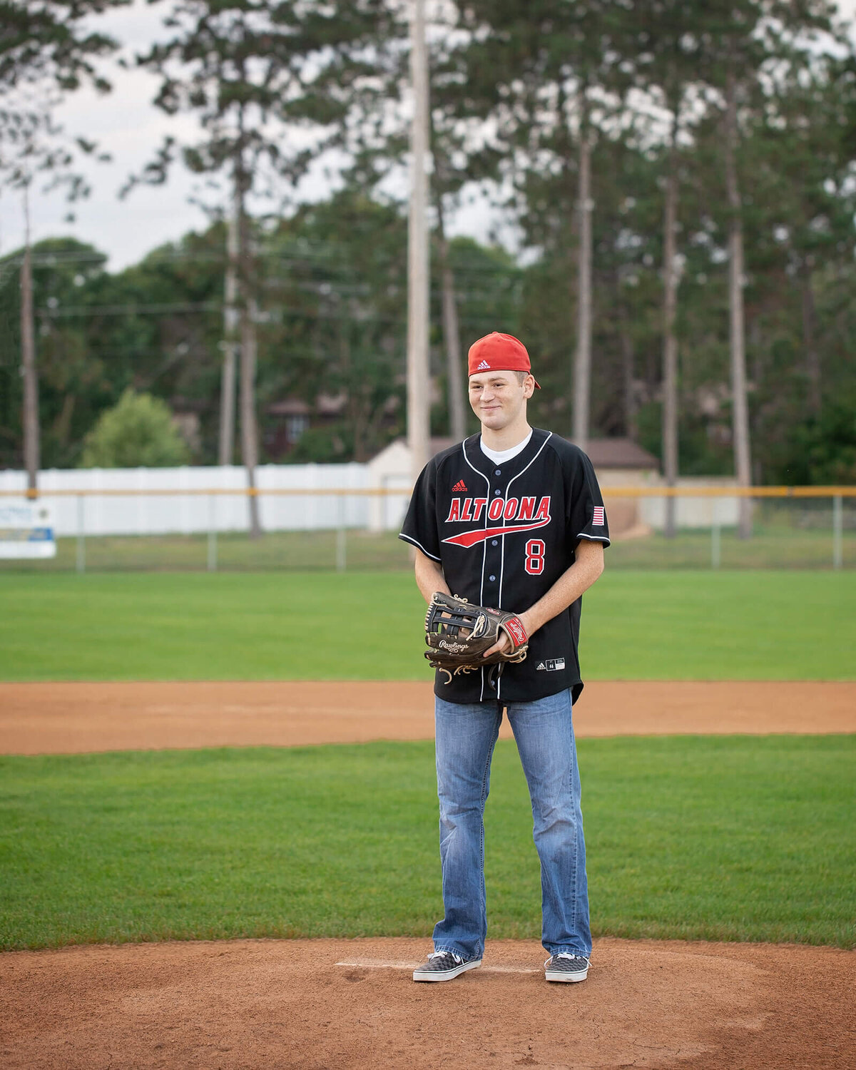 Senior boy on the pitting mound getting ready to pitch.