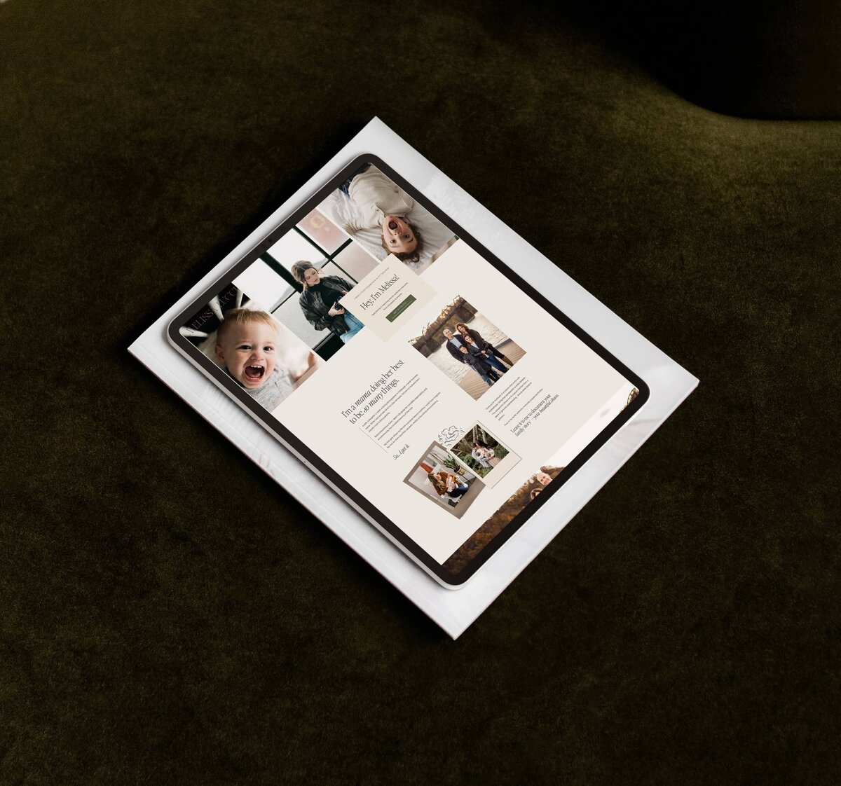 A tablet displaying a beautifully crafted family-themed photography website, complete with various photos and text, rests on an envelope against a dark green background.