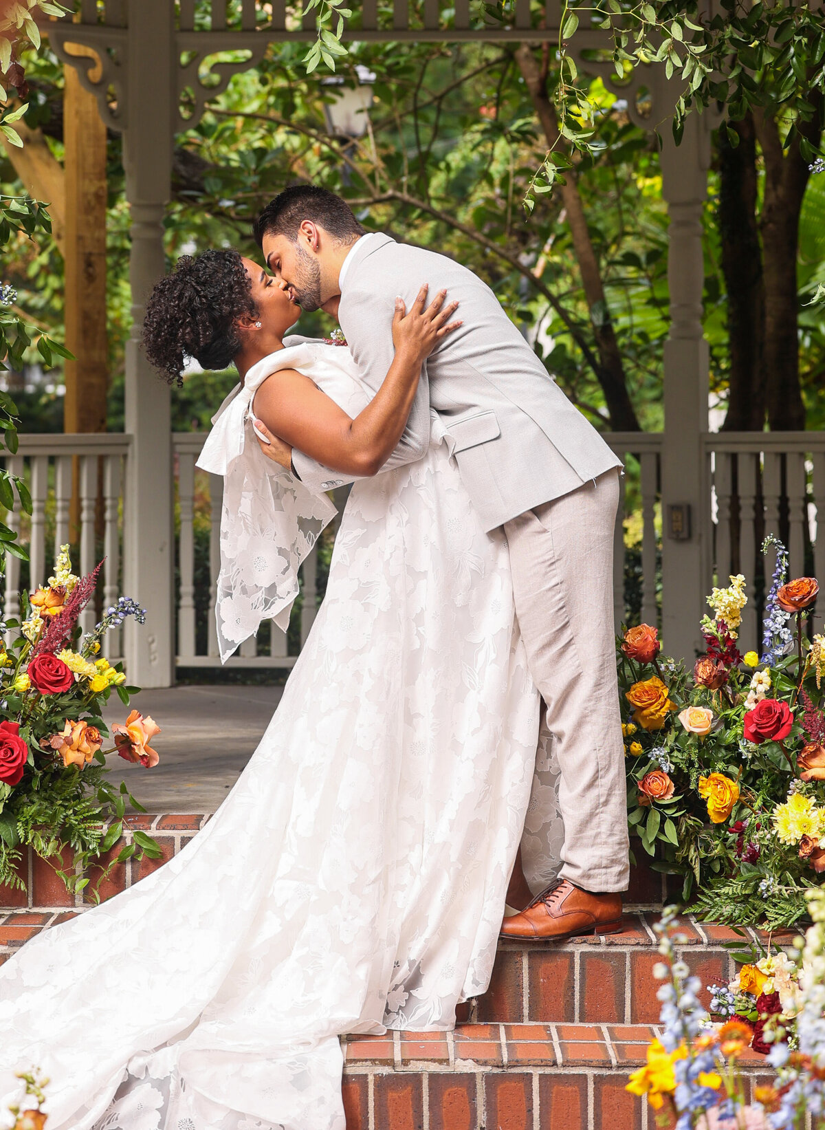 bride and groom sharing first kiss with florals in Orlando Florida by Orlando Wedding photographer Amanda Richardson Photography