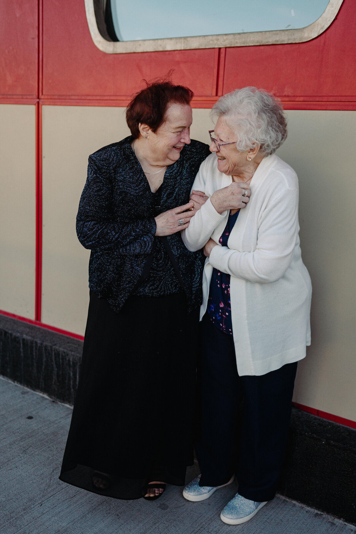 Two grandmothers standing outside of a wedding ceremony
