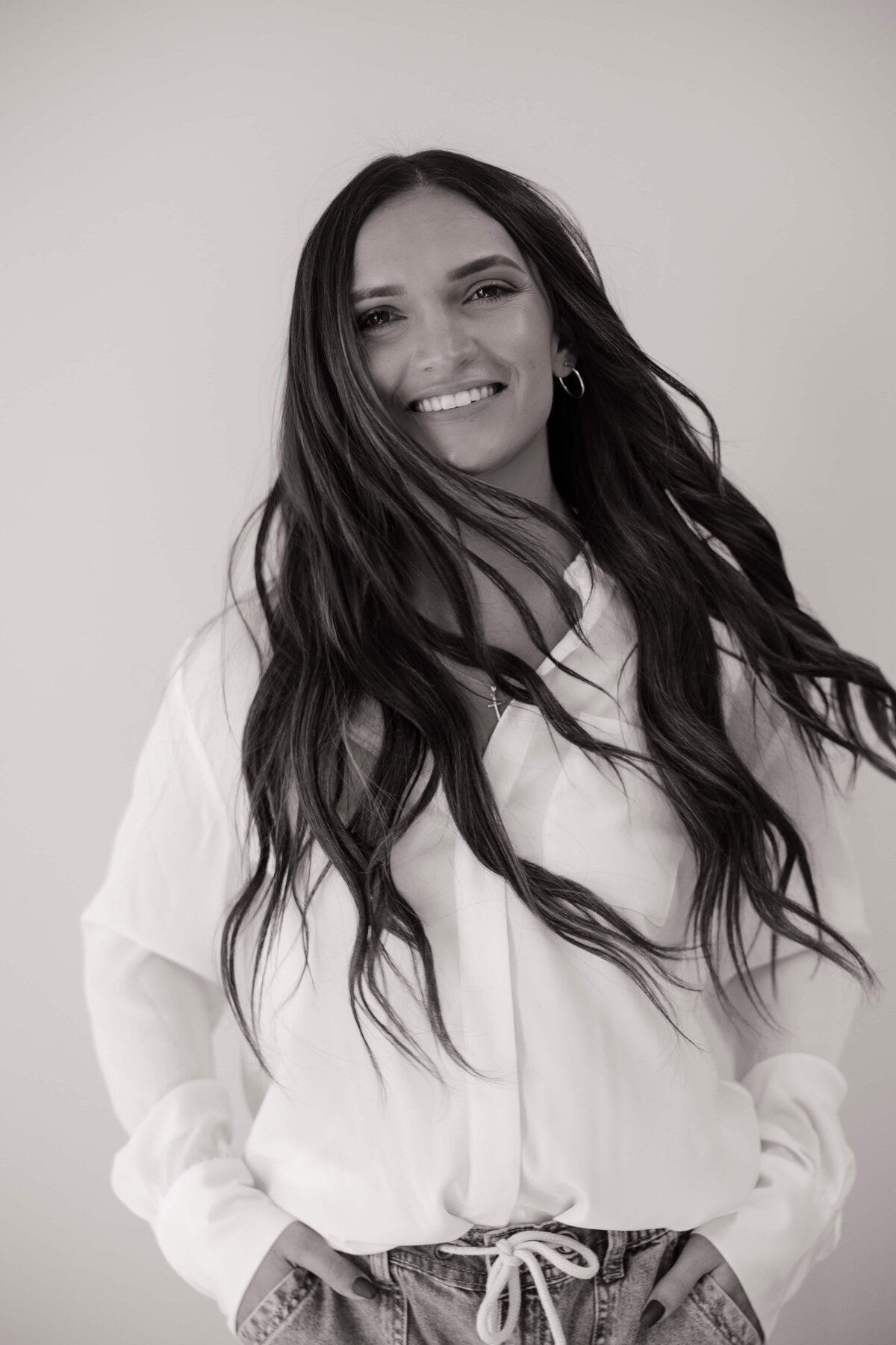 A headshot of a functional health coach smiling during her branding shoot in Loveland, Colorado.