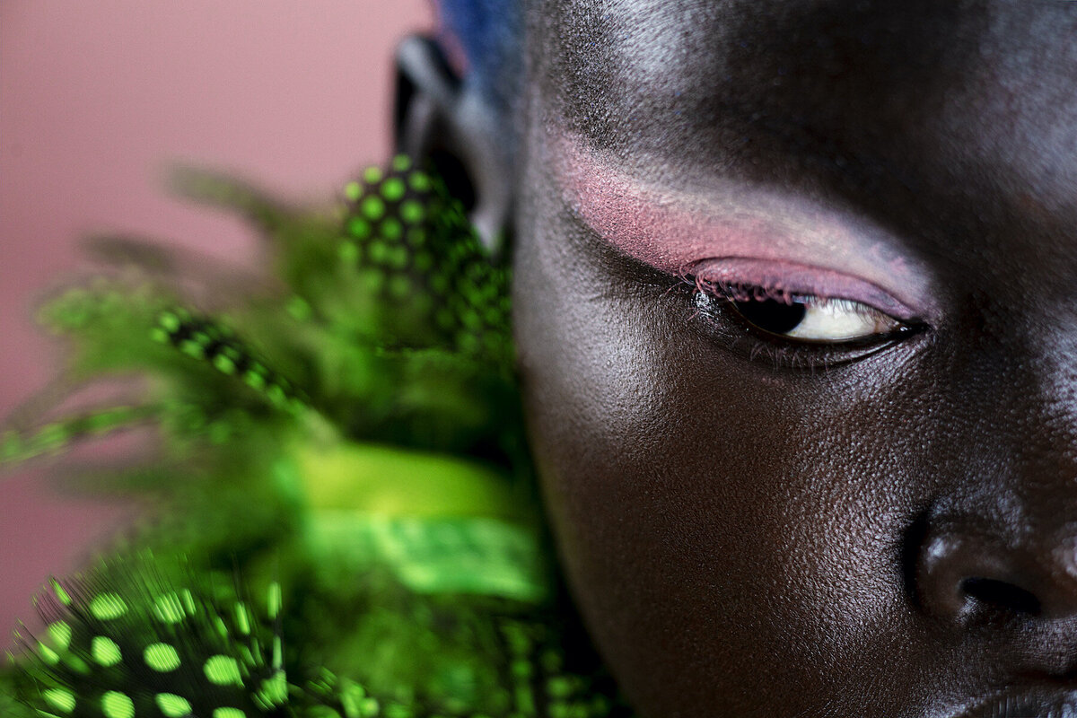 black-woman-green-feathers-editorial-colourful-makeup