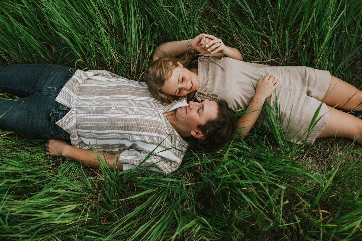 Bride laying in a field, capturing whimsy in Indiana wedding.