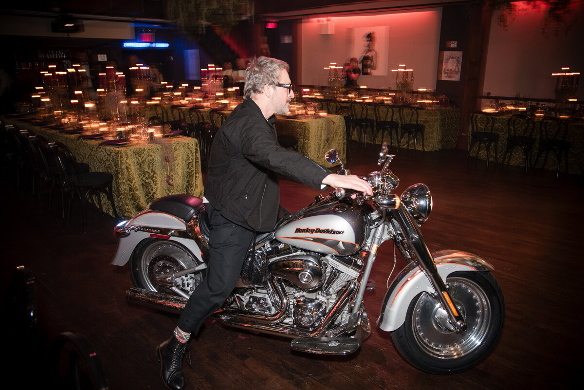 A groom enters his wedding reception on a motorcycle