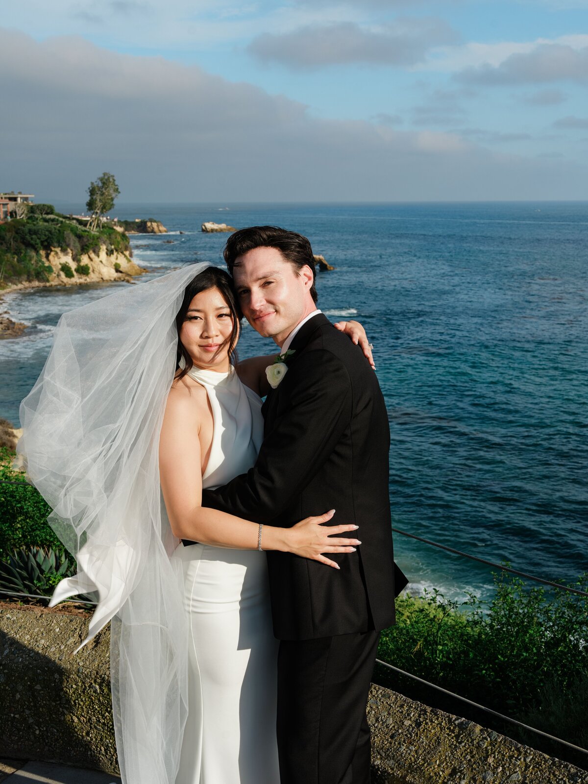 Bride and groom portraits overlooking the ocean at Southern California