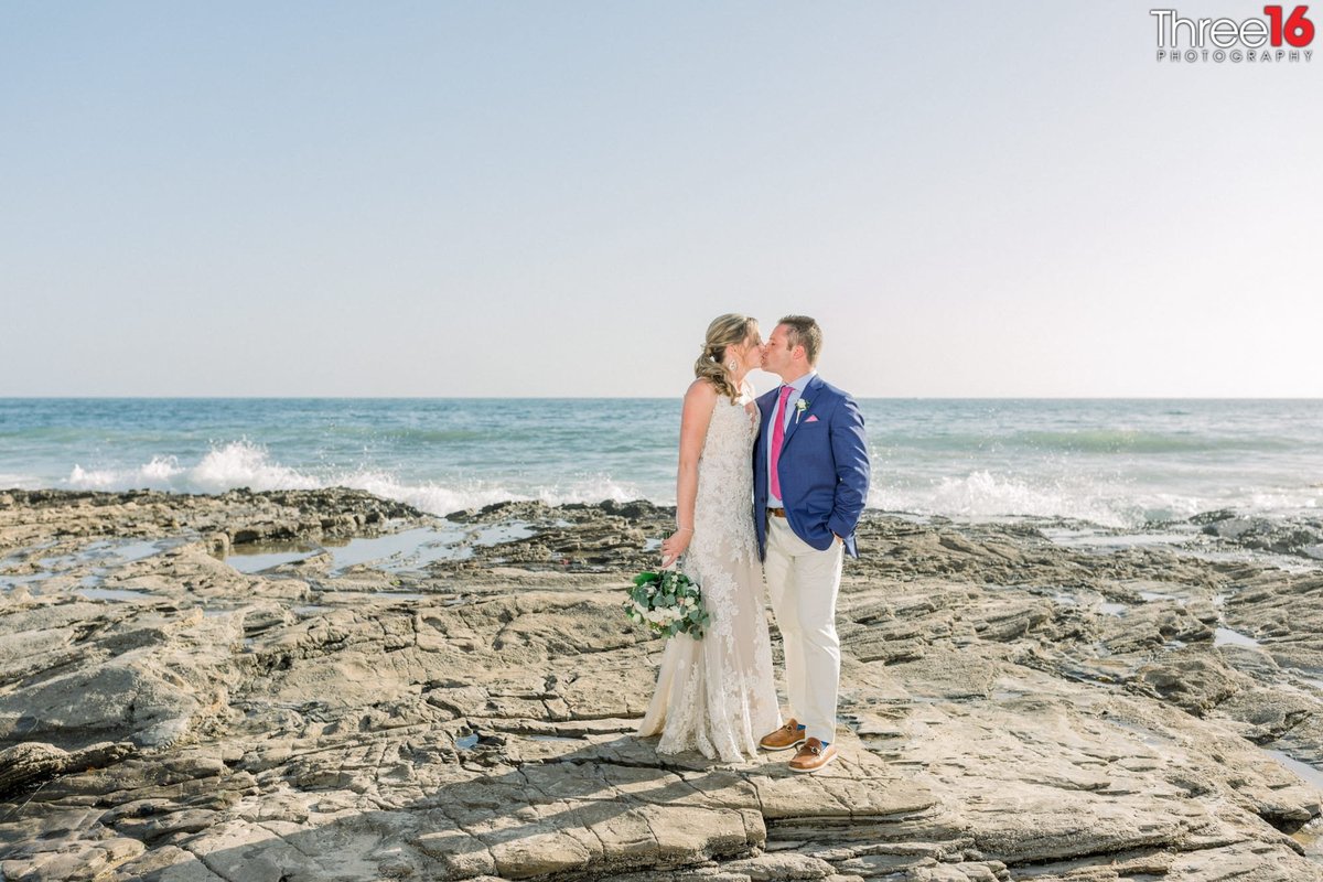 Bride and Groom share a kiss on the sands of Crystal Cove State Beach