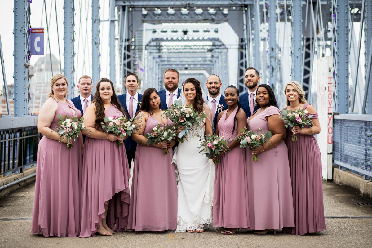 Bridal-party-posing-on-purple-people-bridge