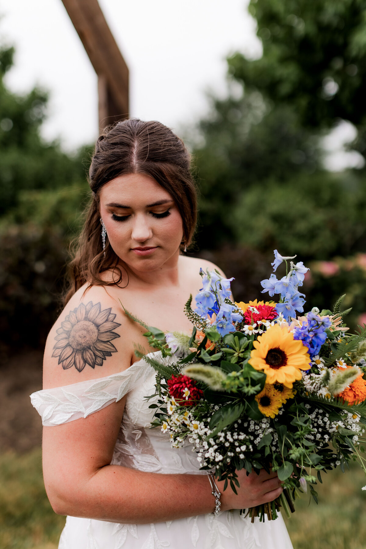 A close up of a bride smelling her flowers.