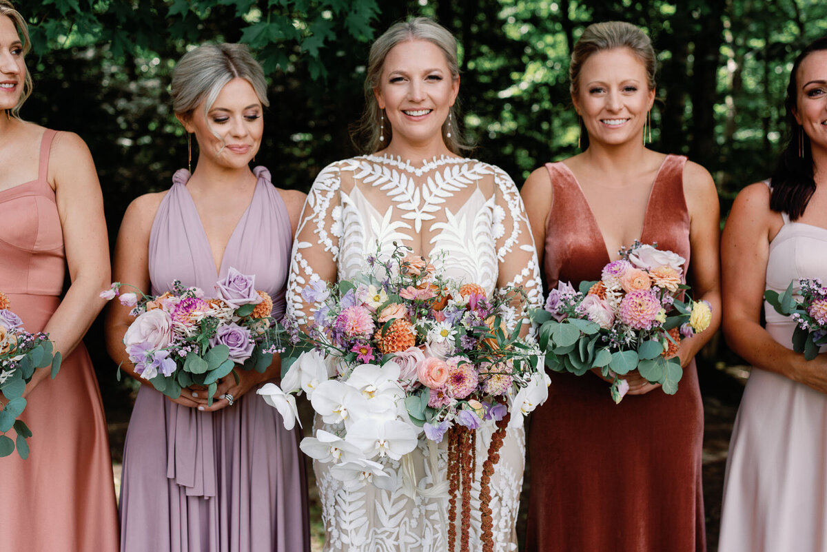bride and bridesmaids at topnotch resort in stowe with pastel florals and mismatched trend dresses