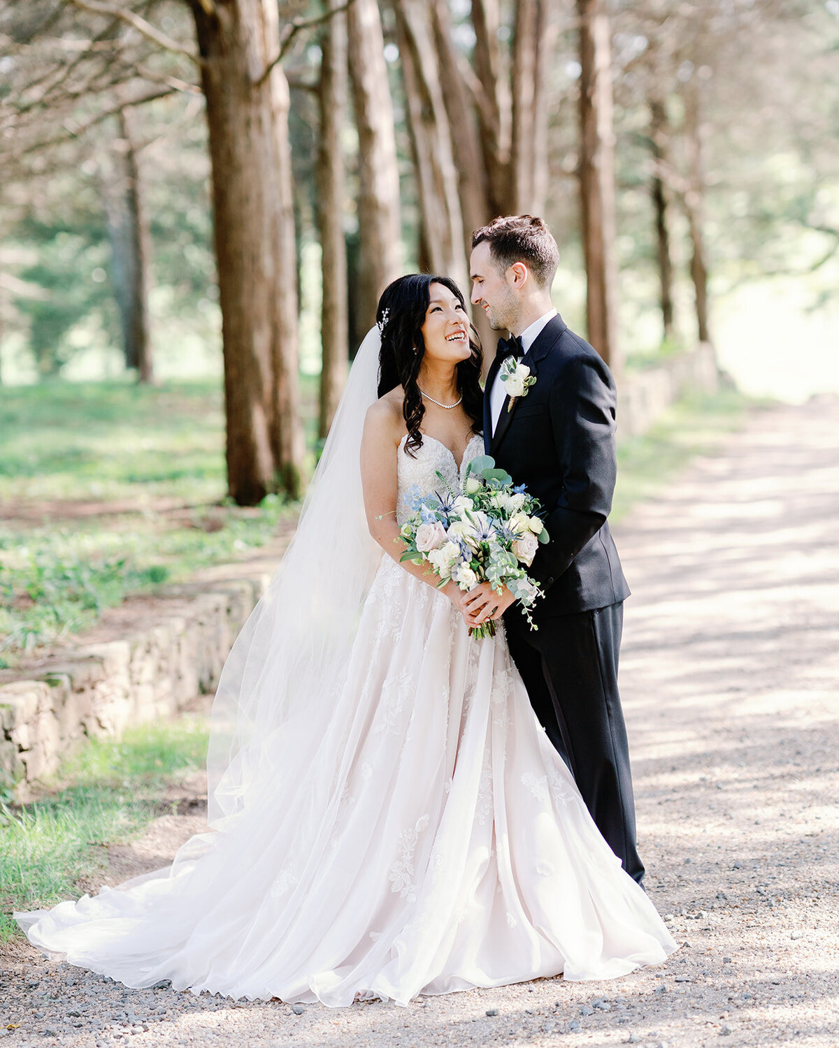 Bride and groom look at eachother for a portrait