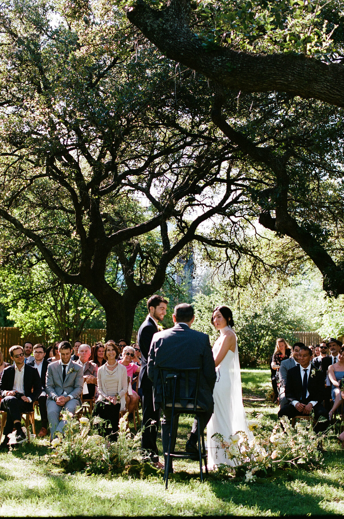Bride and groom exchanging vows at outdoor wedding ceremony at Mattie's Austin