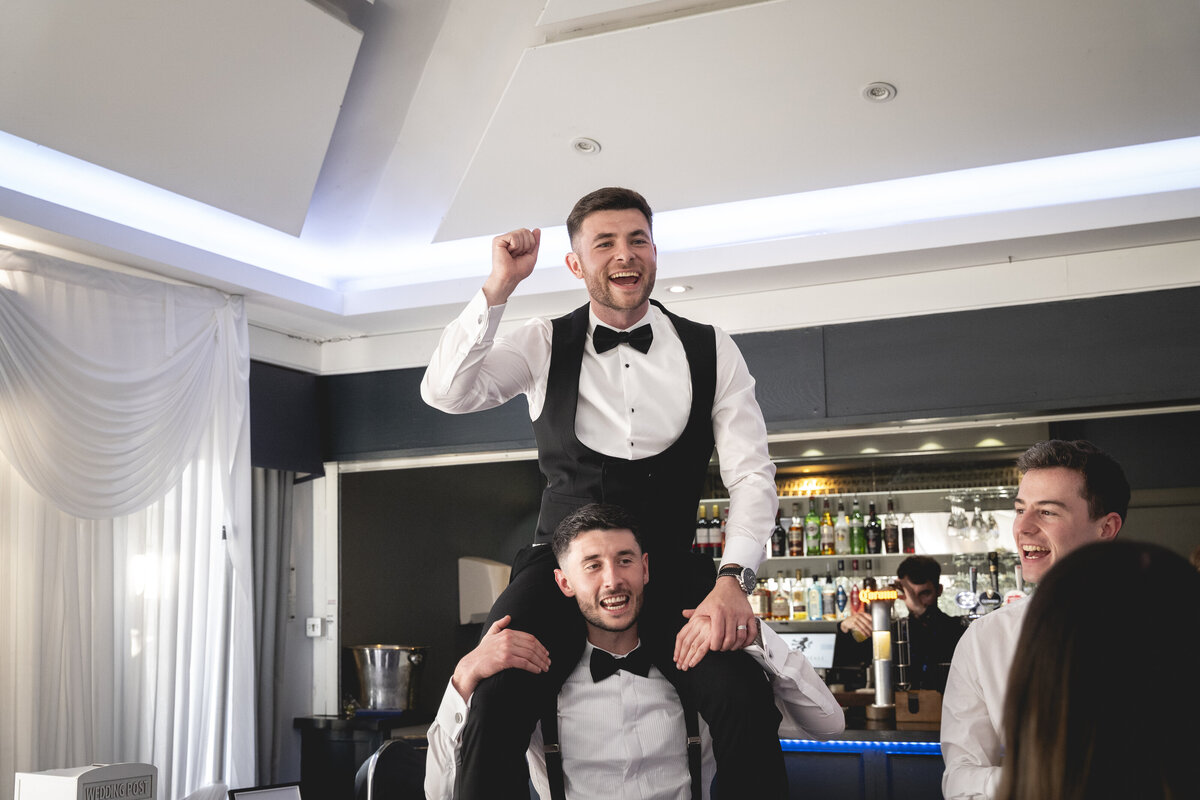 Nathan on his best man's shoulders