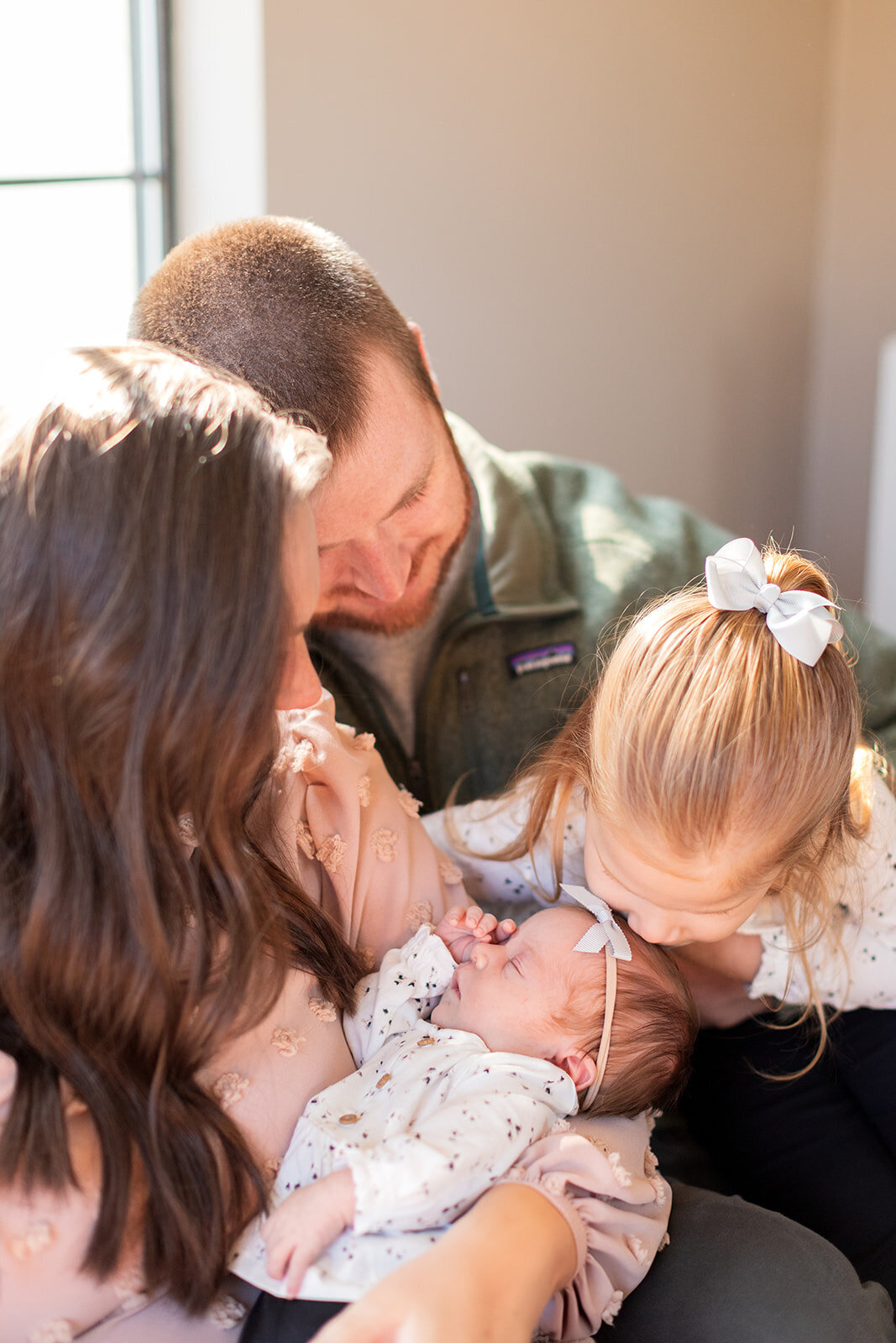 Family cuddling together during lifestyle portrait session