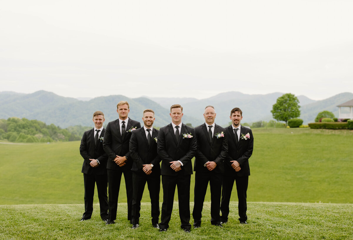 Groomsmen with colorful boutonnieres designed by Abby Grace Florals at NC wedding