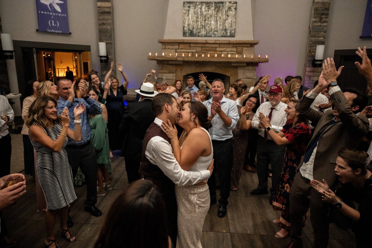 Bride and groom share a kiss at their wedding reception.