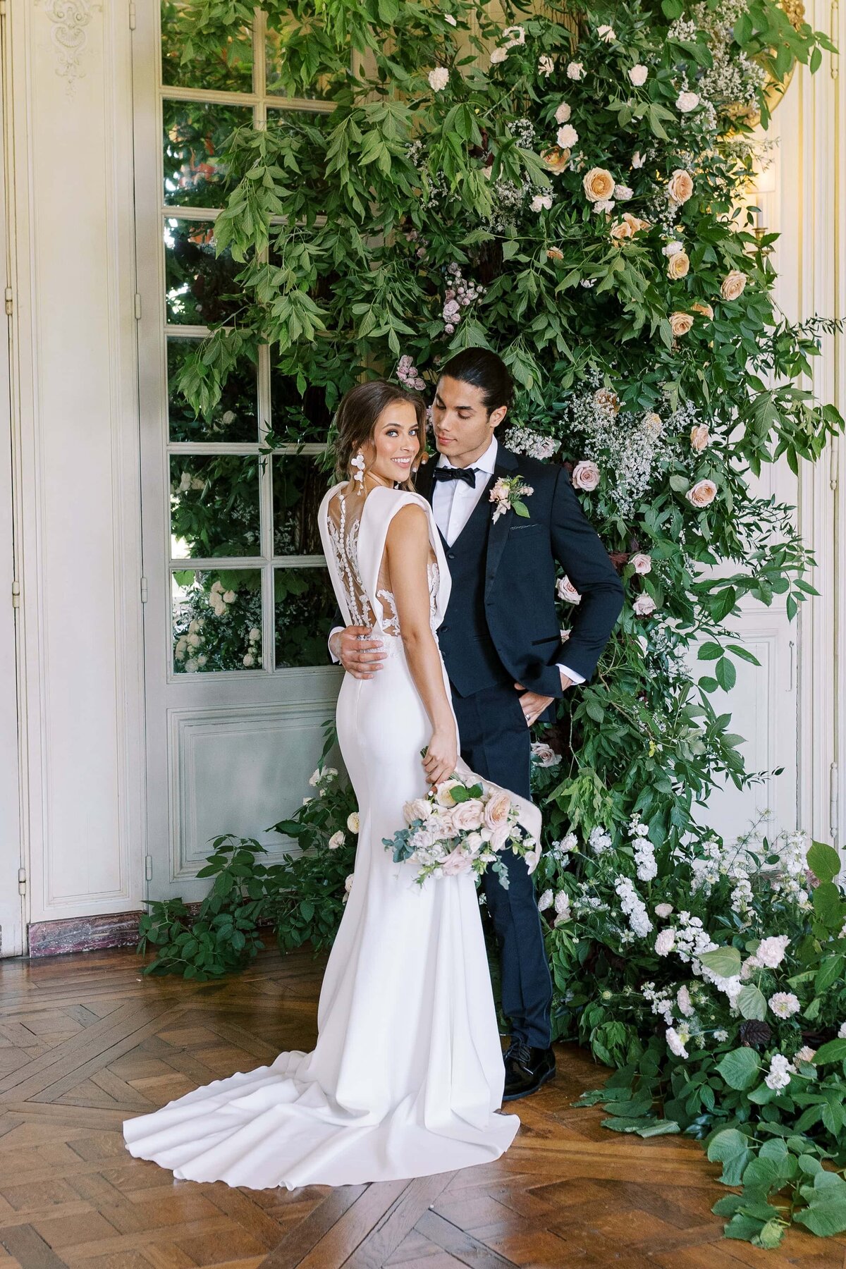 Couple picture where she is smiling in the camera and he is looking at her