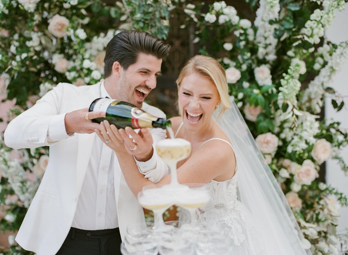 bride + groom pouring champagne tower