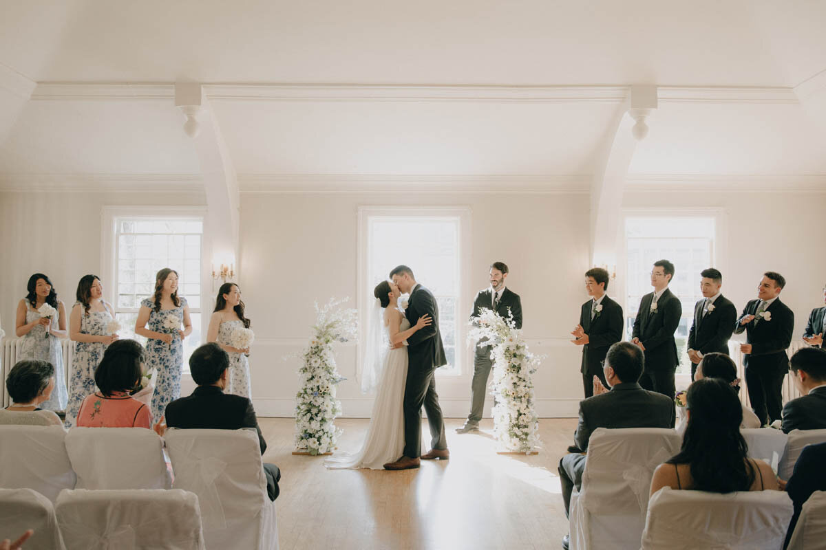 couple kissing during wedding ceremony at rainier chapter house